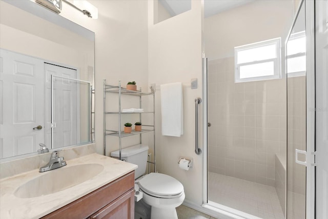 bathroom featuring vanity, toilet, and walk in shower