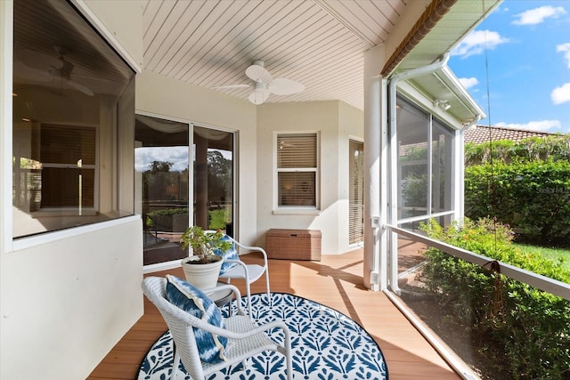 sunroom / solarium with ceiling fan and a healthy amount of sunlight