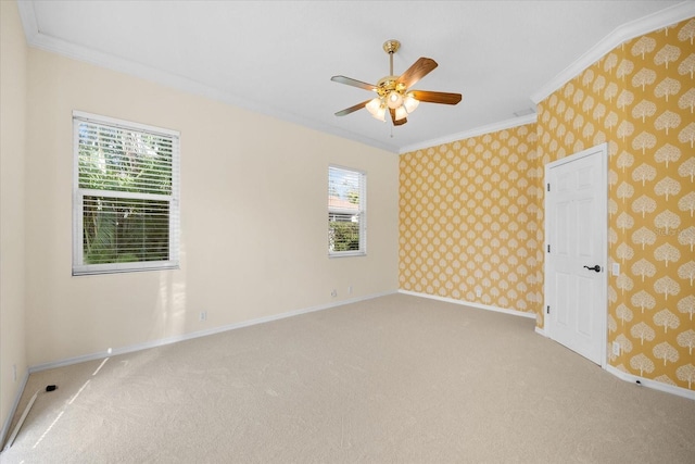 empty room featuring a wealth of natural light, light colored carpet, and ornamental molding