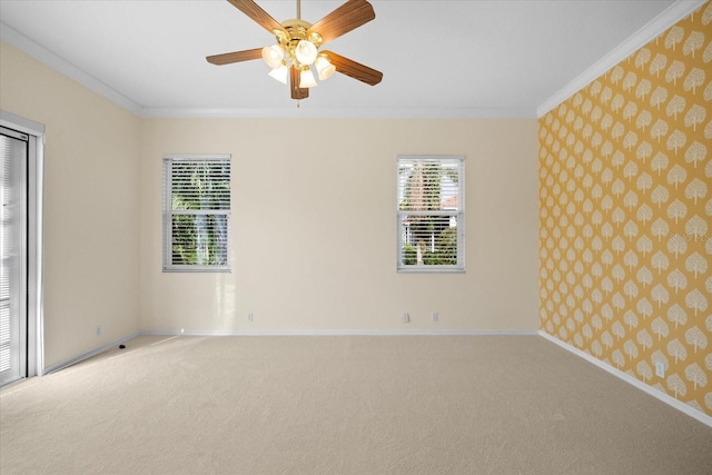 unfurnished room with carpet flooring, ceiling fan, and ornamental molding