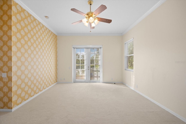 empty room with ceiling fan, french doors, light colored carpet, and ornamental molding