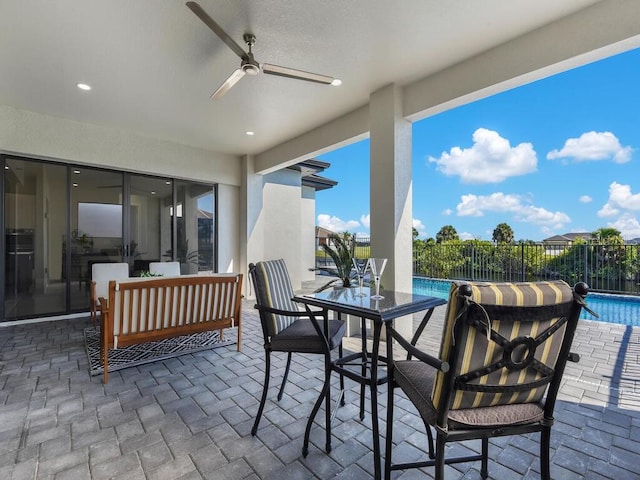 view of patio / terrace with a fenced in pool and ceiling fan