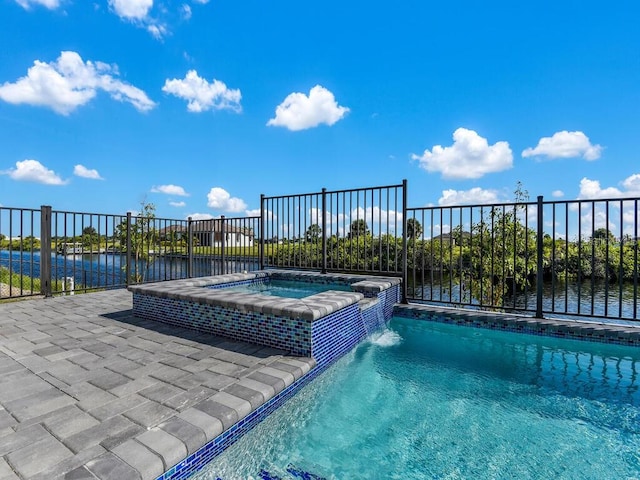 view of swimming pool with a water view, an in ground hot tub, and pool water feature