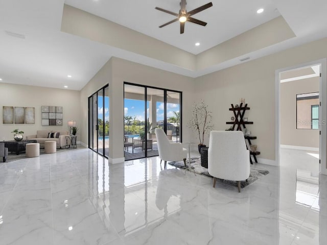 interior space featuring a high ceiling and ceiling fan