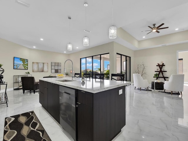 kitchen featuring ceiling fan, pendant lighting, a center island with sink, sink, and dishwasher