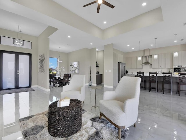 living room with ceiling fan with notable chandelier