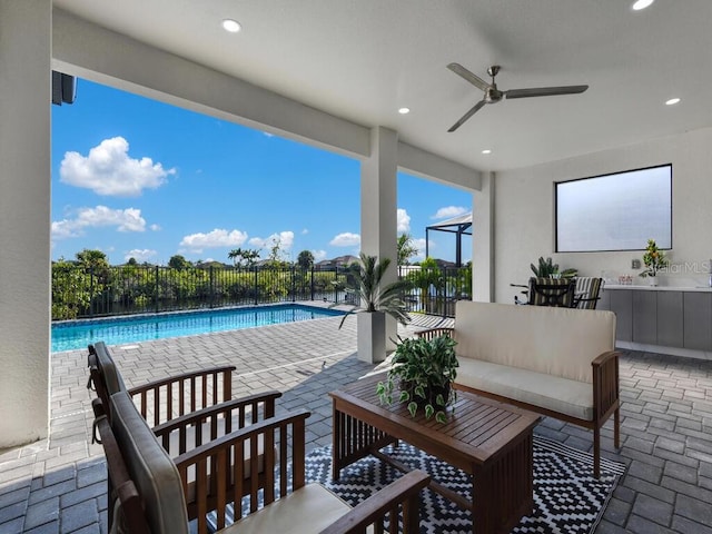 view of patio with ceiling fan and a fenced in pool