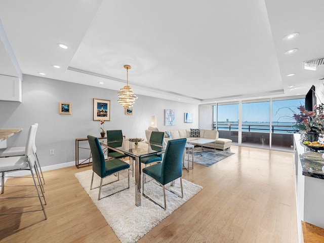 dining area featuring light hardwood / wood-style floors and floor to ceiling windows