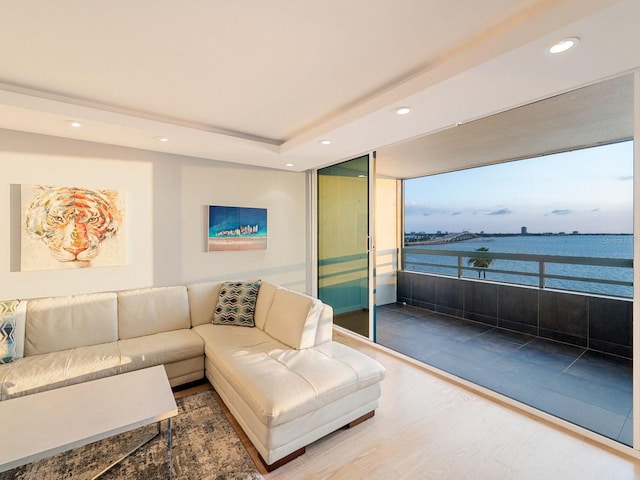 living room featuring a water view and hardwood / wood-style flooring