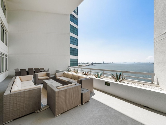 view of patio / terrace featuring outdoor lounge area, a water view, and a balcony