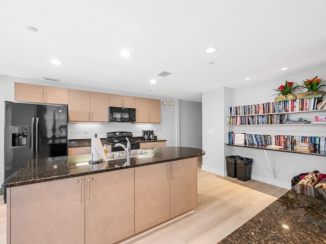 kitchen with light brown cabinetry, sink, black appliances, and light wood-type flooring