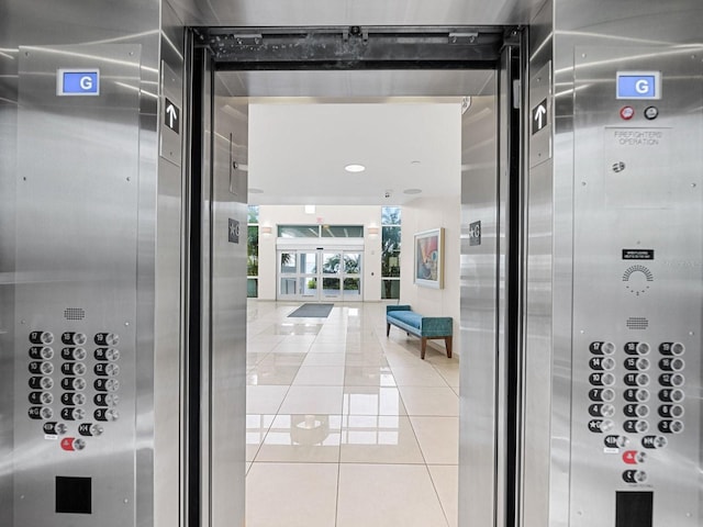 interior space with elevator and light tile patterned floors