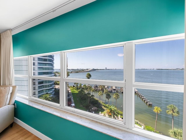 unfurnished sunroom featuring plenty of natural light and a water view