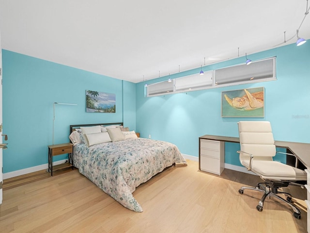 bedroom featuring light wood-type flooring and baseboards