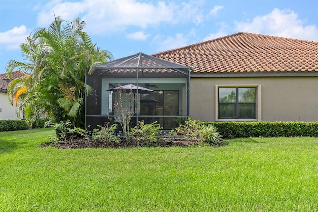 rear view of house featuring a yard and a lanai