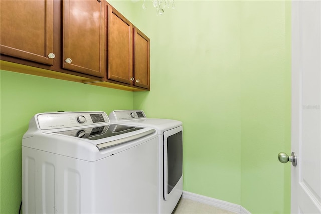 laundry area featuring washer and dryer and cabinets