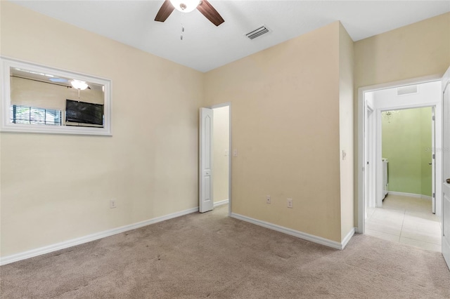 unfurnished room featuring light carpet and ceiling fan