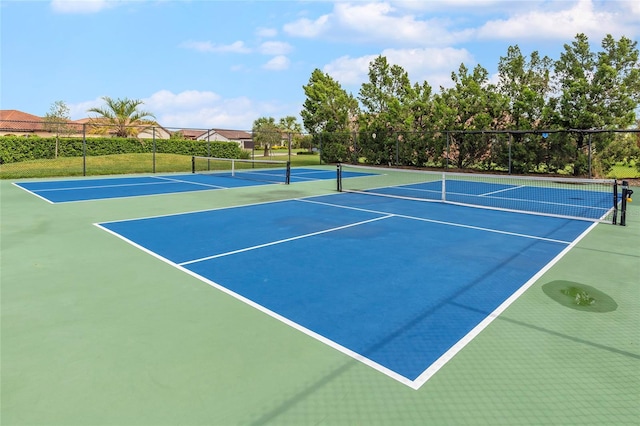 view of tennis court with basketball hoop