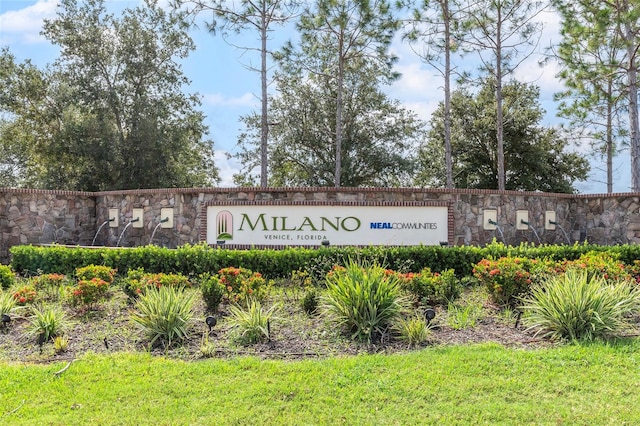 community / neighborhood sign featuring a lawn