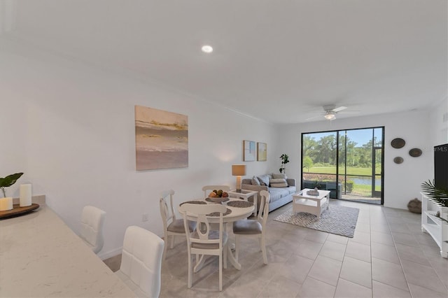 tiled dining area with ceiling fan