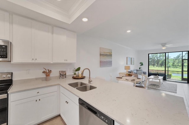 kitchen featuring stainless steel appliances, crown molding, sink, light tile patterned flooring, and white cabinets