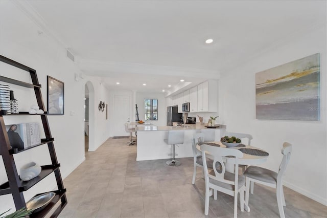 tiled dining room with ornamental molding