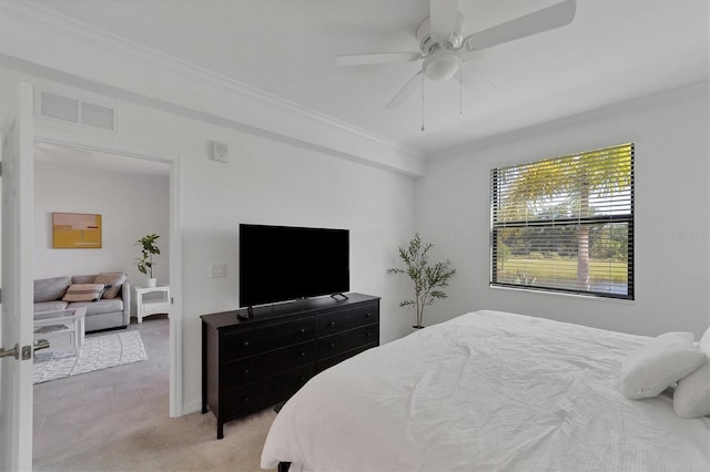 bedroom with crown molding, light carpet, and ceiling fan