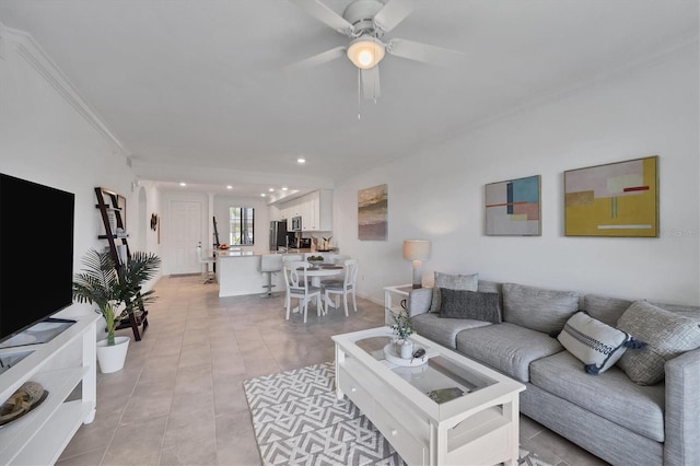 tiled living room with crown molding and ceiling fan