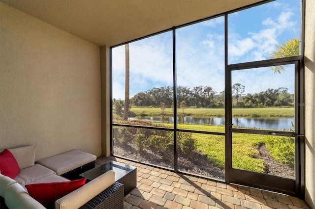 sunroom / solarium with a water view