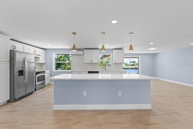 6912 Kenwood Dr, North Port, FL 34287 - kitchen featuring appliances with stainless steel finishes, tasteful backsplash, recessed lighting, a spacious island, and white cabinets