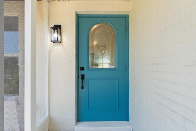 doorway to property with stucco siding