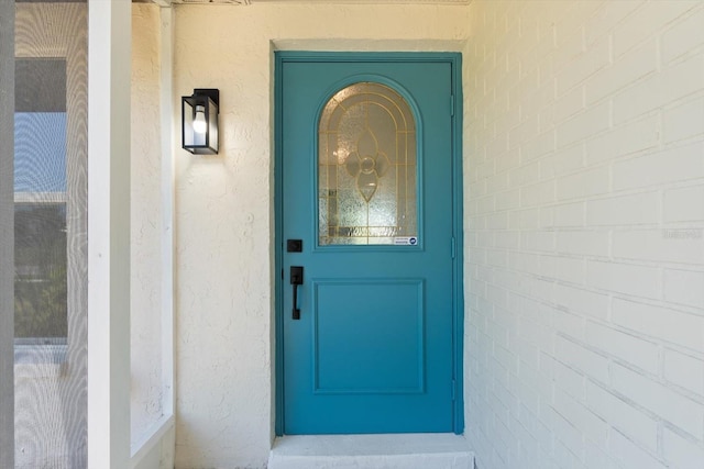 6912 Kenwood Dr, North Port, FL 34287 - doorway to property with stucco siding