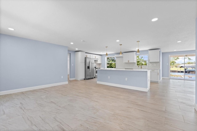 6912 Kenwood Dr, North Port, FL 34287 - unfurnished living room featuring recessed lighting, plenty of natural light, and baseboards