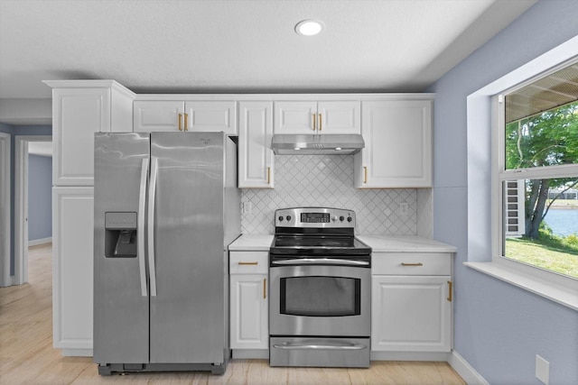 6912 Kenwood Dr, North Port, FL 34287 - kitchen featuring stainless steel appliances, under cabinet range hood, healthy amount of natural light, tasteful backsplash, and recessed lighting