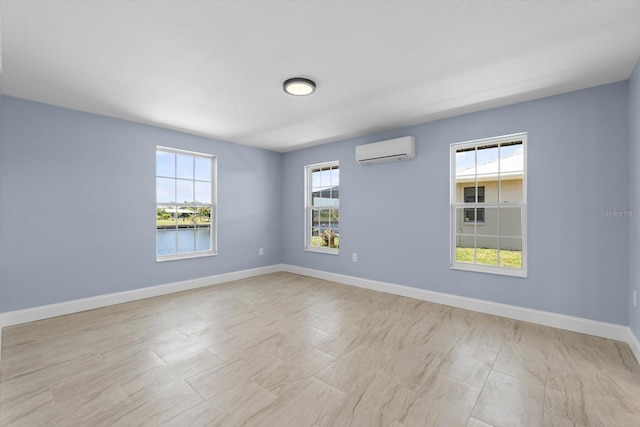 spare room featuring a water view and a wall mounted AC