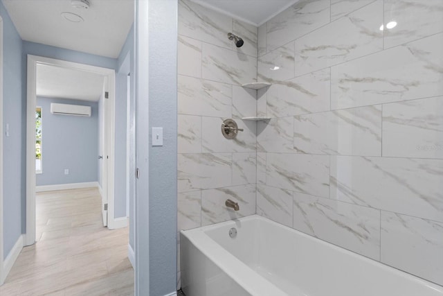 full bathroom with a textured wall, shower / bathing tub combination, a wall mounted AC, and baseboards