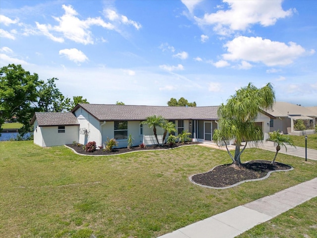 ranch-style home with a garage, stucco siding, and a front yard