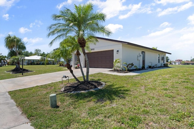 view of front of home with a front lawn and a garage