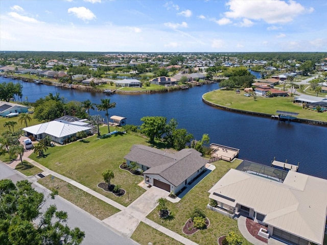 drone / aerial view featuring a water view and a residential view