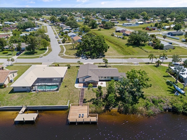 birds eye view of property with a water view and a residential view