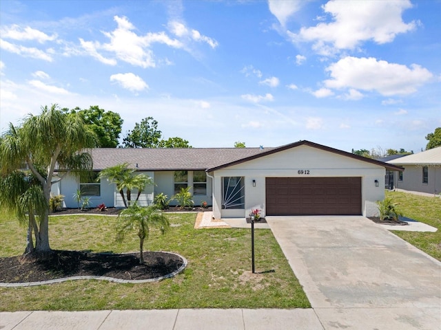 ranch-style house with a garage, concrete driveway, a front lawn, and brick siding