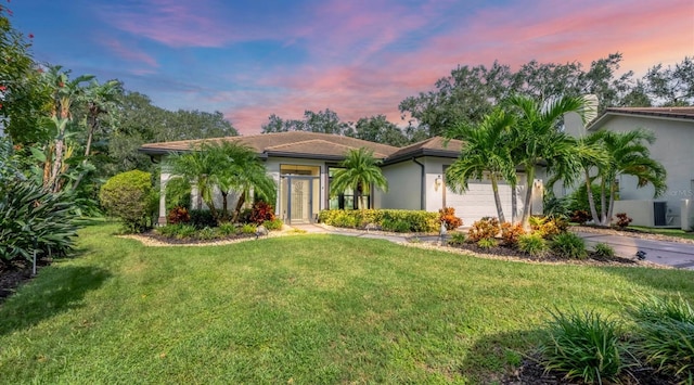 view of front of property featuring a garage and a yard