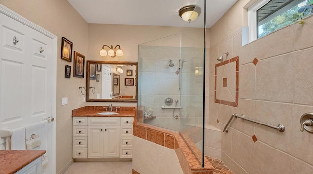 bathroom with vanity and tiled shower