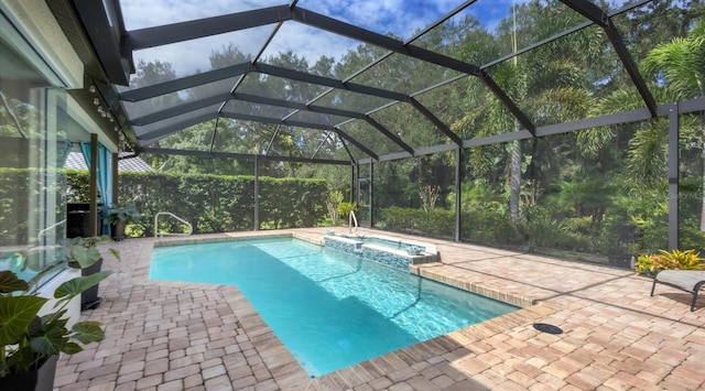 view of swimming pool with a lanai, an in ground hot tub, and a patio