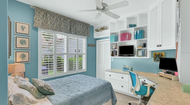 tiled bedroom with a closet and ceiling fan