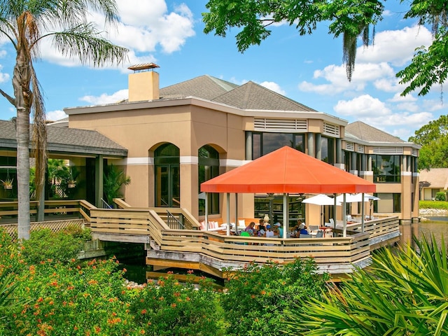 rear view of property with a wooden deck