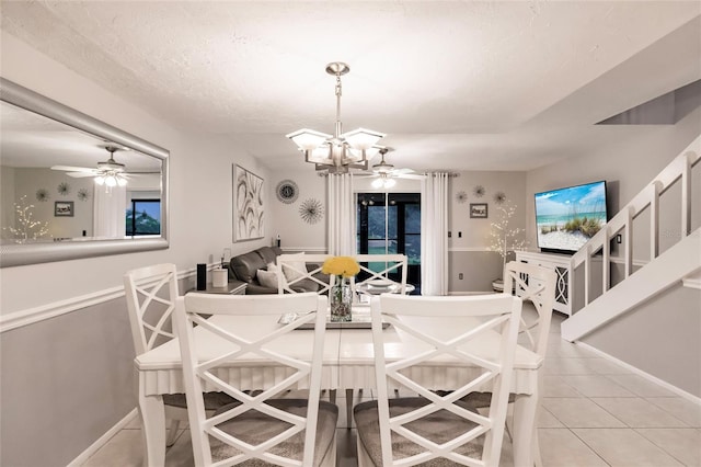 tiled dining space with a notable chandelier and a textured ceiling