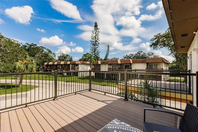 wooden deck featuring a yard