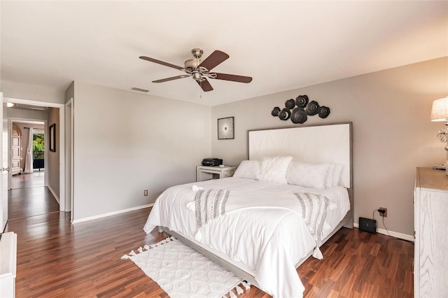 bedroom with ceiling fan and dark wood-type flooring