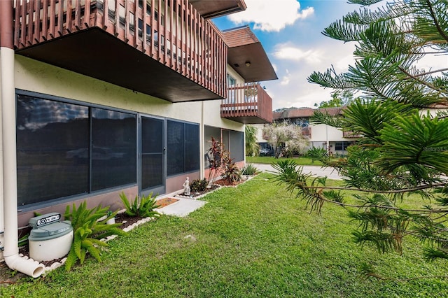 view of yard with a balcony